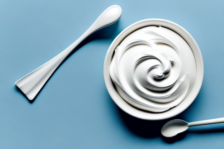 A bowl of fluffy white whipped icing with a spoon